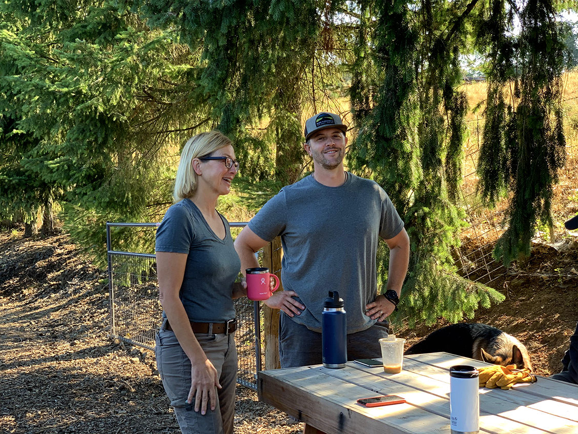 Brenda and Tyler having a conversation at an outdoor table